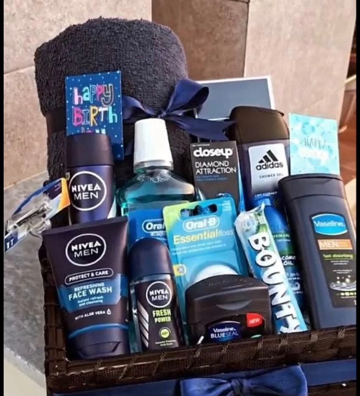 Men's grooming gift basket with Nivea products, Adidas deodorant, and a birthday card.