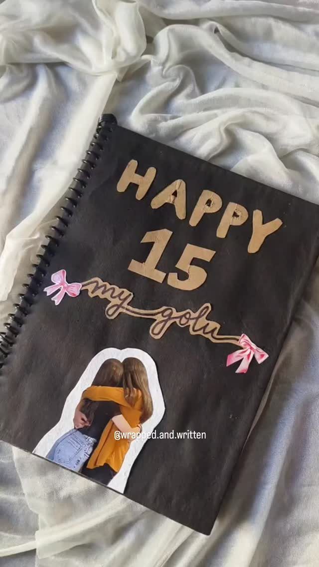 Customized black birthday notebook with gold lettering, pink bows, and a personal photo.