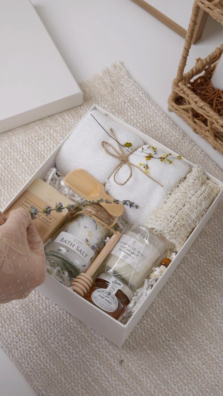 Spa gift set in a white box with towel, bath salts, and candle.