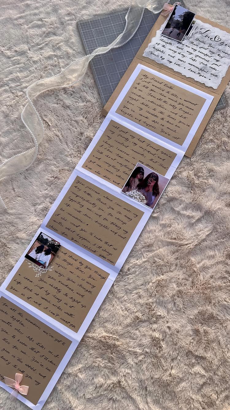 Handmade accordion scrapbook with handwritten notes and couple photos on beige fur.