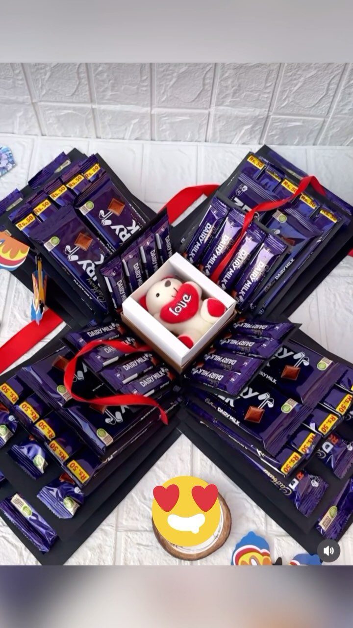 Chocolate gift box filled with purple chocolate bars and a small teddy bear.