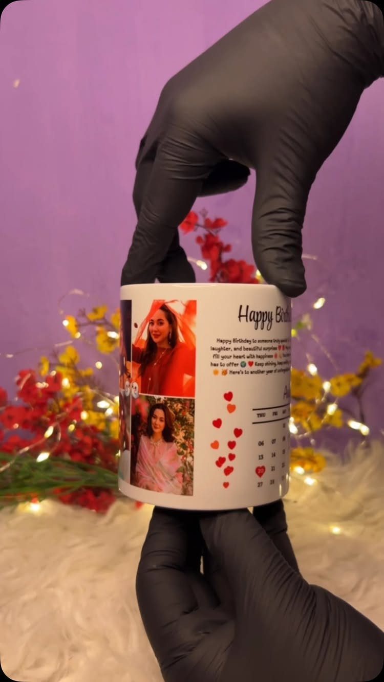 Custom white coffee mug with photos and birthday text held by gloved hands.