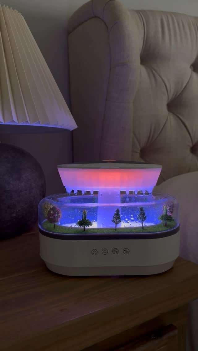 Miniature landscape humidifier with blue lights on a wooden bedside table