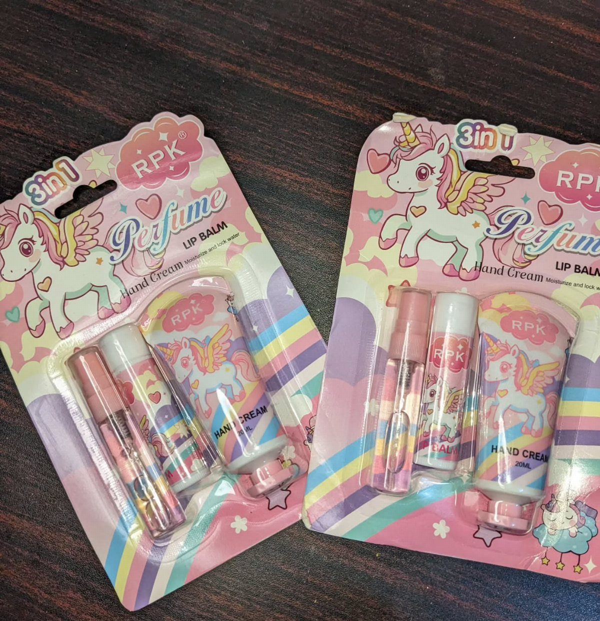 Two pink unicorn beauty gift sets with perfume, lip balm, and hand cream.