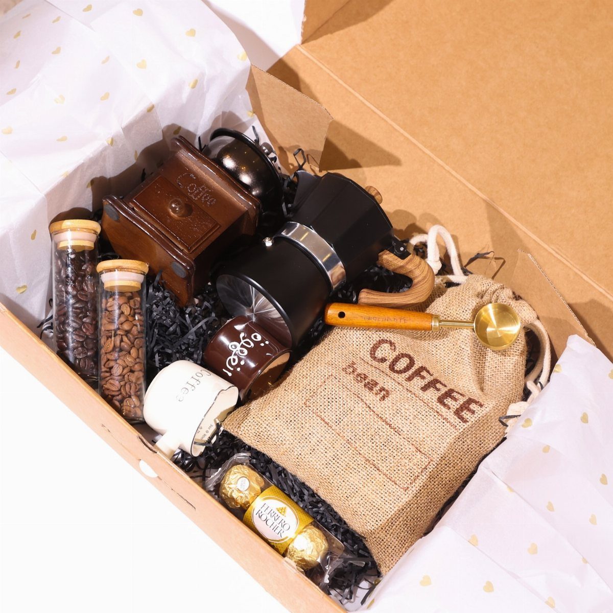 Coffee gift set in a box with grinder, French press, and coffee beans.