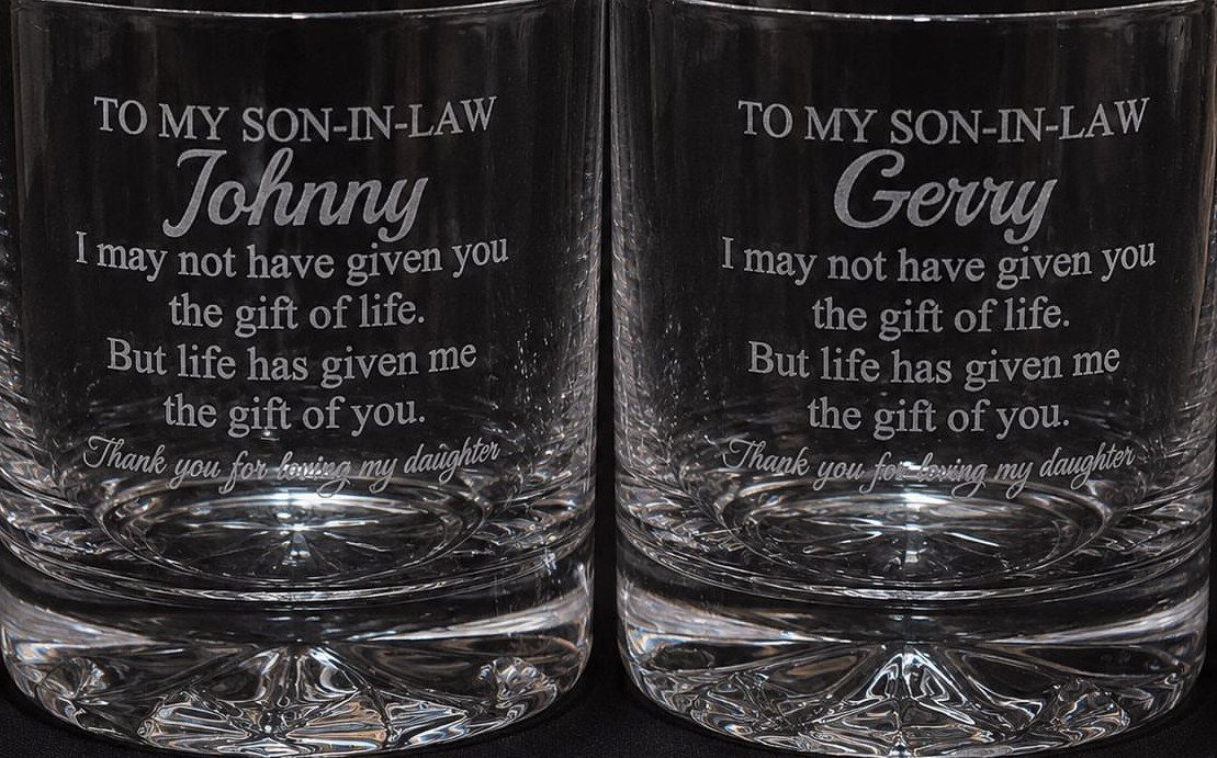 Two etched whiskey glasses with personalized messages for sons-in-law Johnny and Gerry.