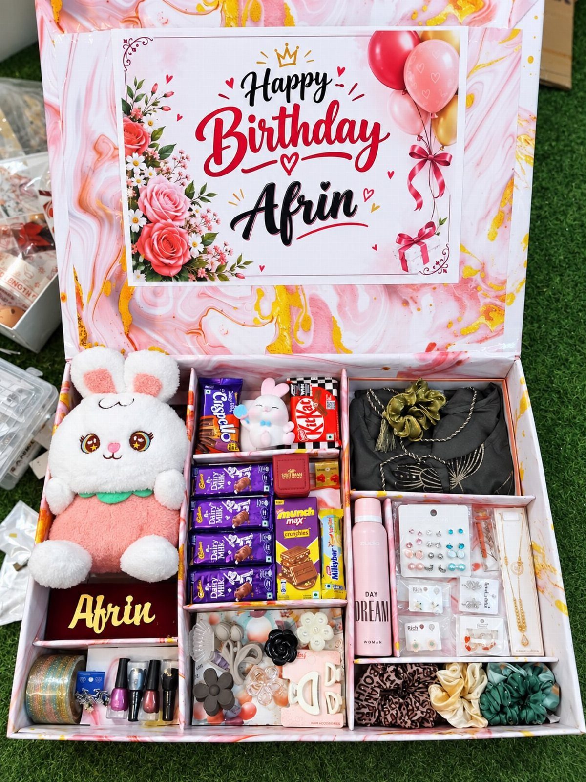 Birthday bento box filled with a plush bunny, chocolates, jewelry, and beauty accessories.