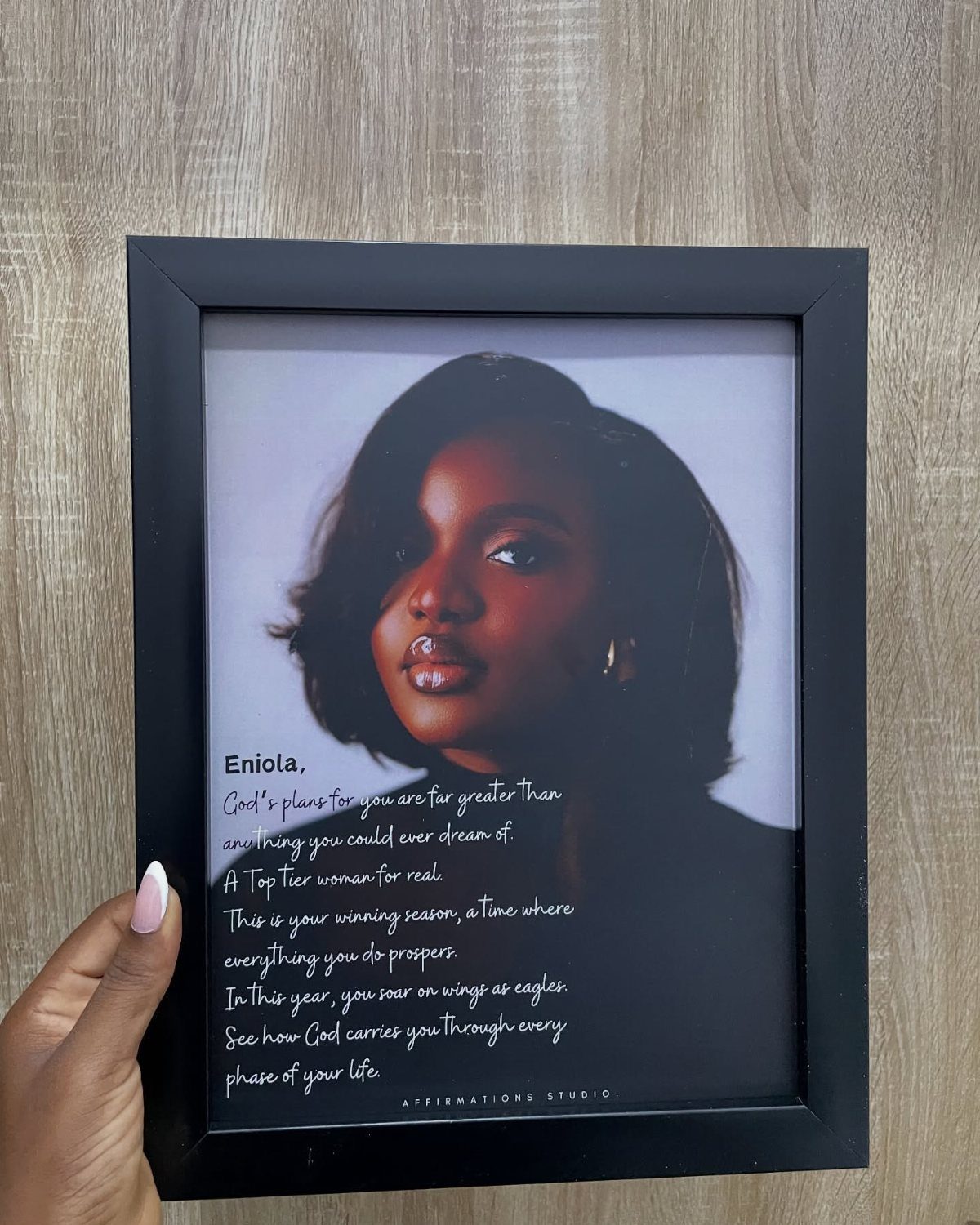 Framed portrait of a woman with a personalized inspirational quote printed below her.