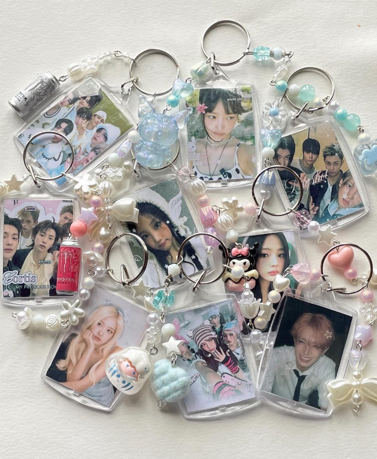 Photo keychains with portrait pictures and pastel beads on a white background