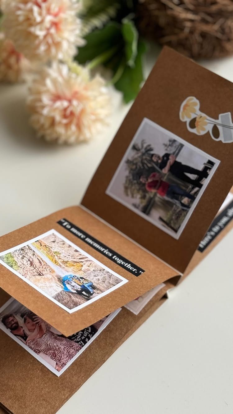 Handmade brown cardboard photo album with printed pictures and a handwritten memory note.