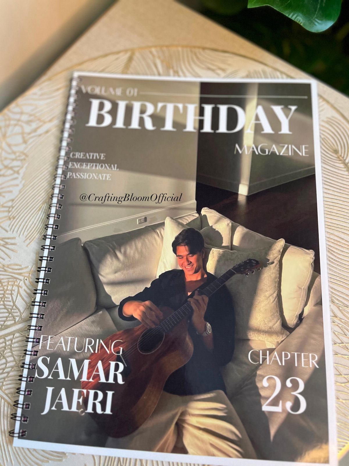 Spiral-bound birthday magazine photo book featuring a man playing a guitar on a sofa.