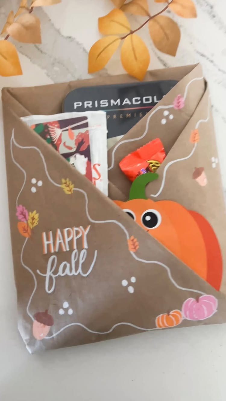 Autumn themed gift wrap containing Prismacolor colored pencils and small treats.
