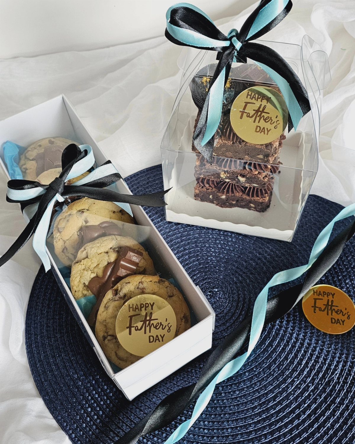 Chocolate chip cookies and brownies in gift boxes with Father's Day stickers.