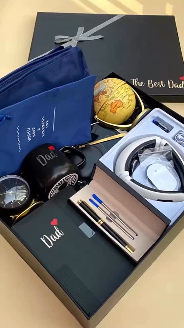Gift box for Dad containing a mug, headphones, globe, and stationery items.