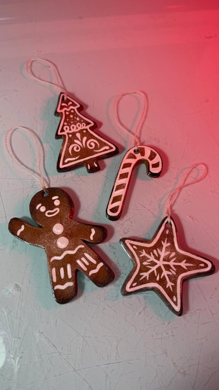 Gingerbread-style Christmas ornaments in shapes of a tree, candy cane, man, and star.