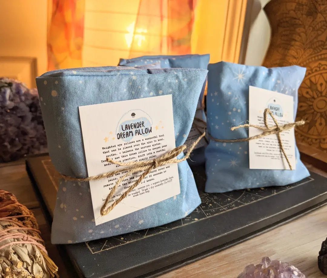 Three blue star-patterned lavender dream pillows tied with twine and white labels.