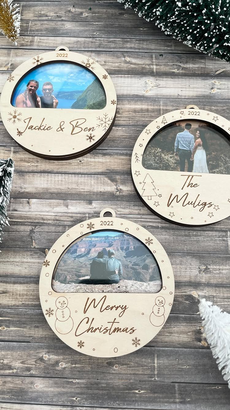 Three circular wooden photo ornaments with personalized engravings on a rustic wooden background.