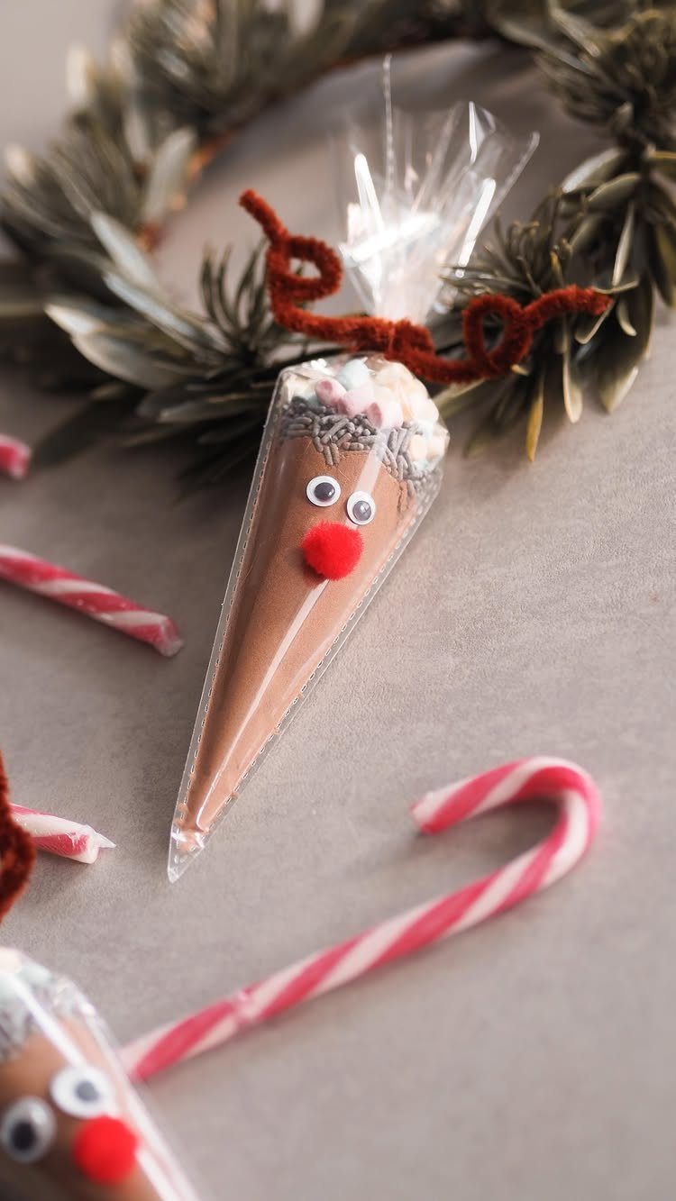 Chocolate filled cone decorated as a reindeer with candy canes and a wreath.
