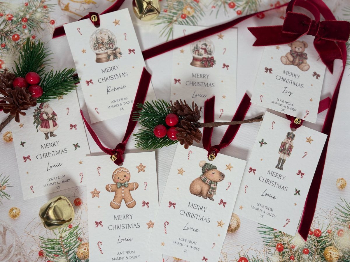 White Christmas gift tags with festive illustrations and red ribbons on a white background