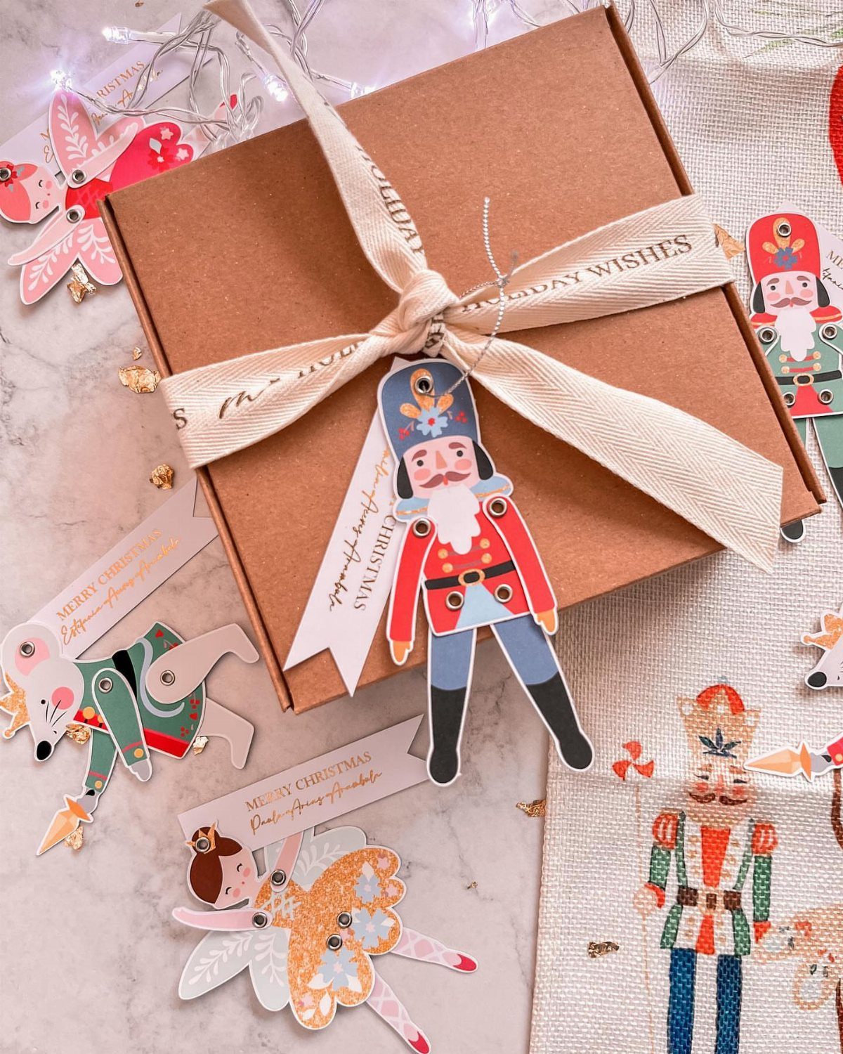 Nutcracker-shaped gift tag attached to a brown gift box with a cream ribbon.