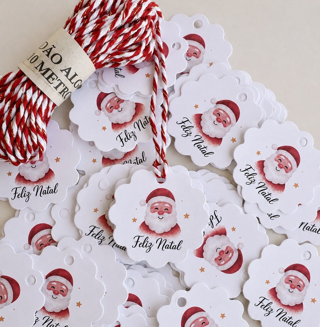 White scalloped gift tags with Santa Claus illustrations and red and white twine.