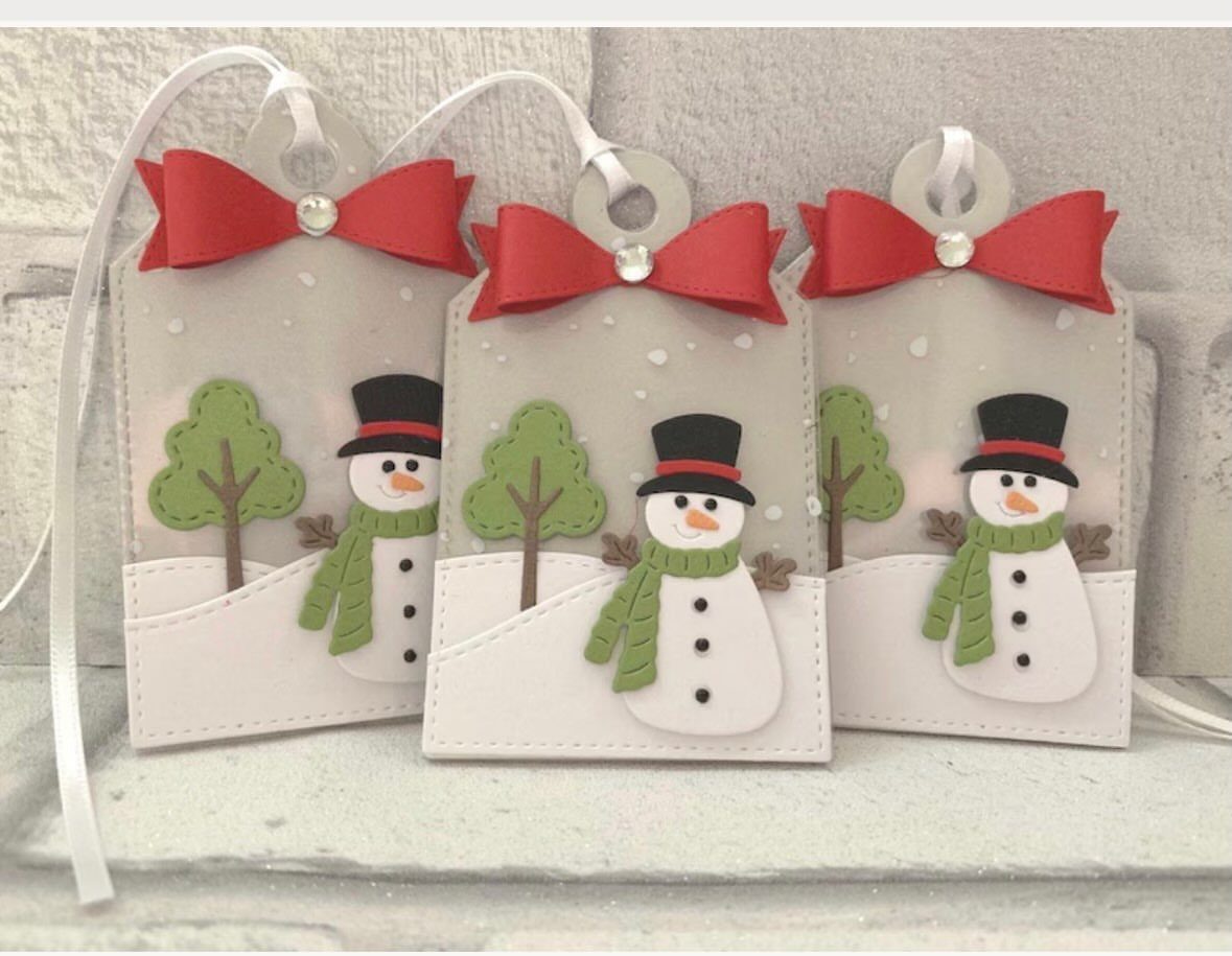 Three snowman gift tags with red bows and green scarves on white cardstock.