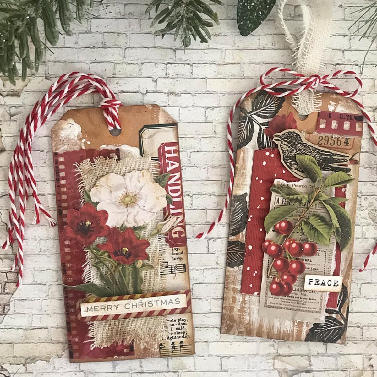 Vintage Christmas gift tags with botanical prints and red twine on white brick.
