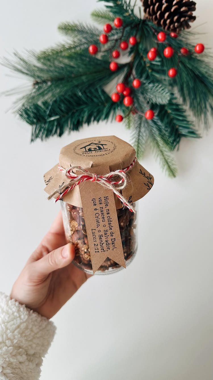 Glass jar filled with edibles, wrapped with brown paper and red twine.