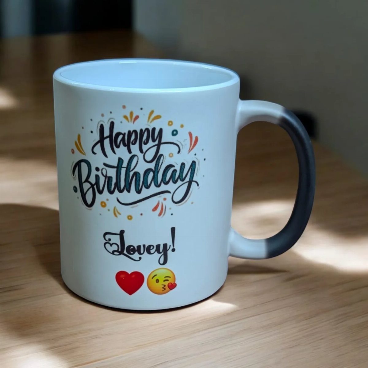 White ceramic coffee mug with Happy Birthday Lovey text on wooden table
