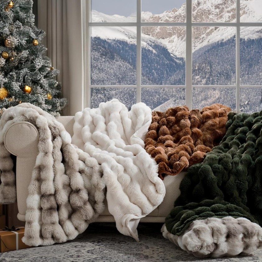 Plush faux fur throw blankets in various colors draped over a cozy sofa.