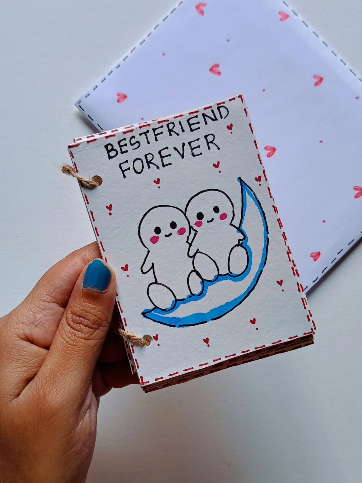 Handmade best friend notebook with cute characters on a blue crescent moon.