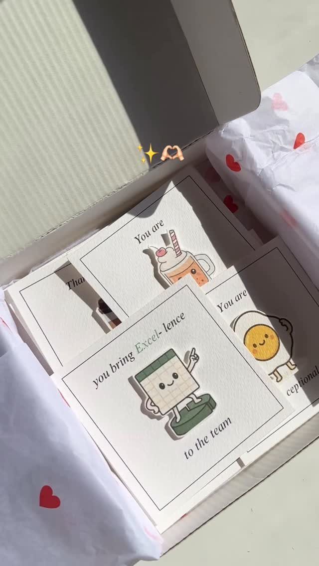 Punny coworker appreciation cards with cute illustrations inside a white gift box.