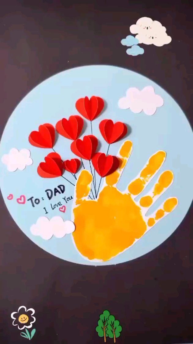 Yellow handprint art with red paper hearts and text for dad on blue background