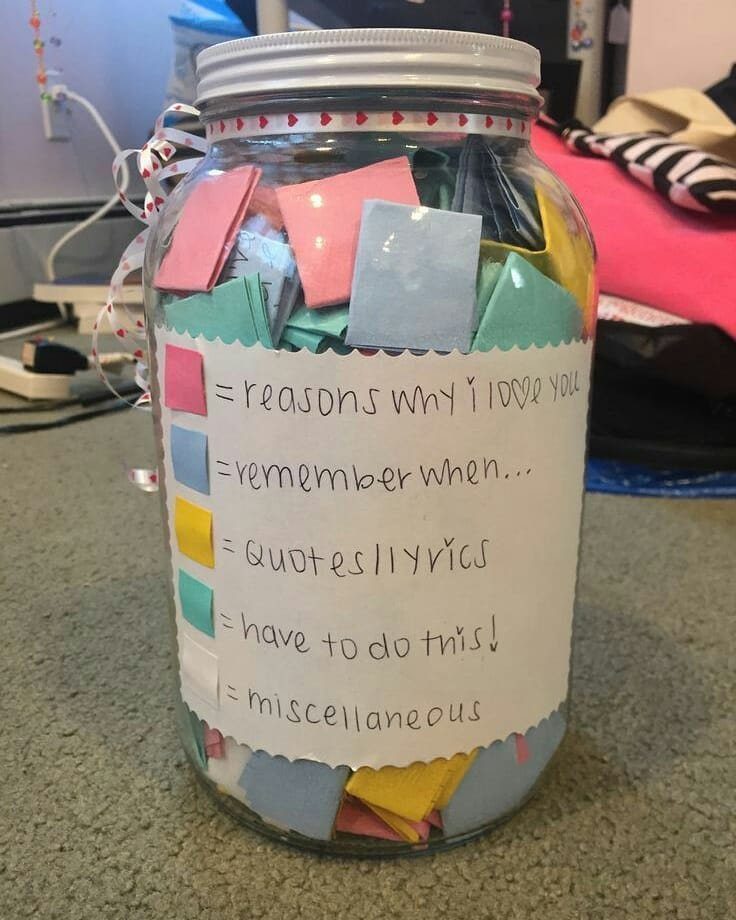 Glass memory jar filled with colorful notes and a handwritten category label.