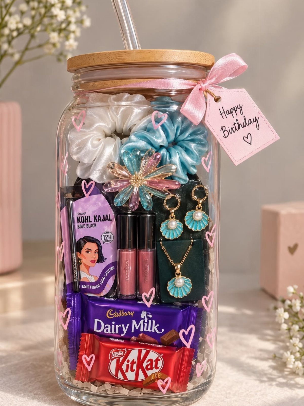 Glass gift jar filled with chocolates, jewelry, and accessories with a birthday tag.