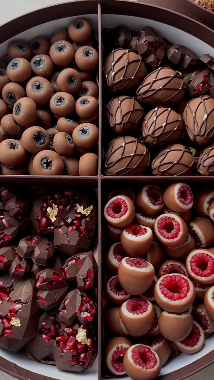 Round chocolate gift box divided into four sections with assorted gourmet chocolates.