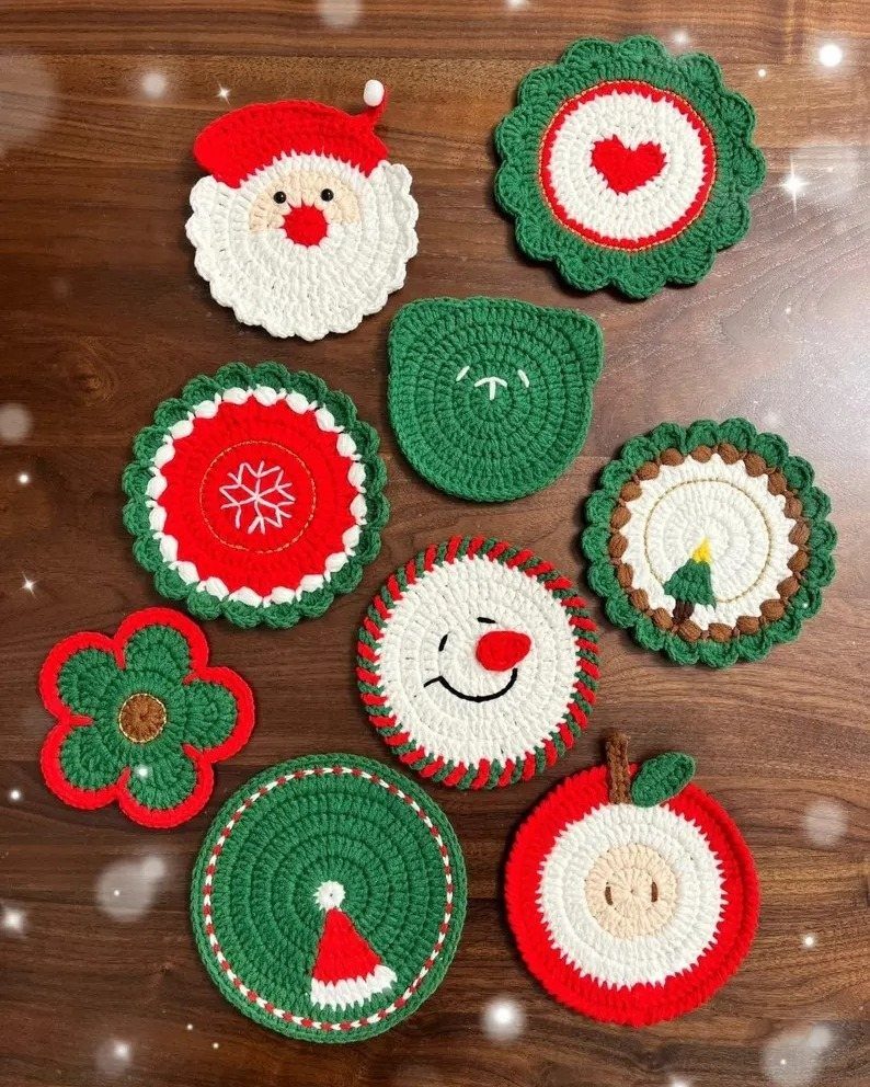 Crocheted Christmas coasters in various shapes and colors on a wooden table.