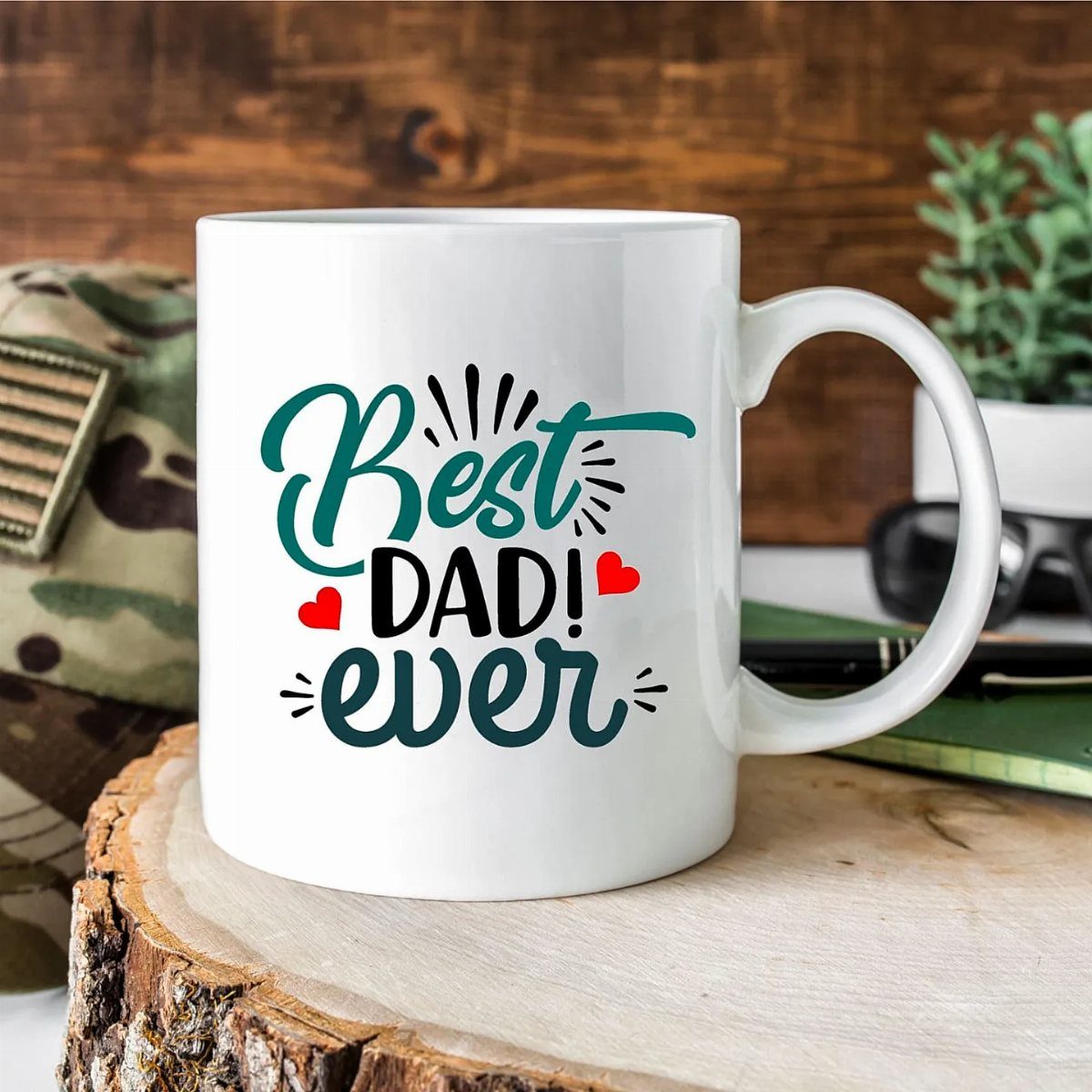 White ceramic mug with Best Dad Ever text on a wooden slice.