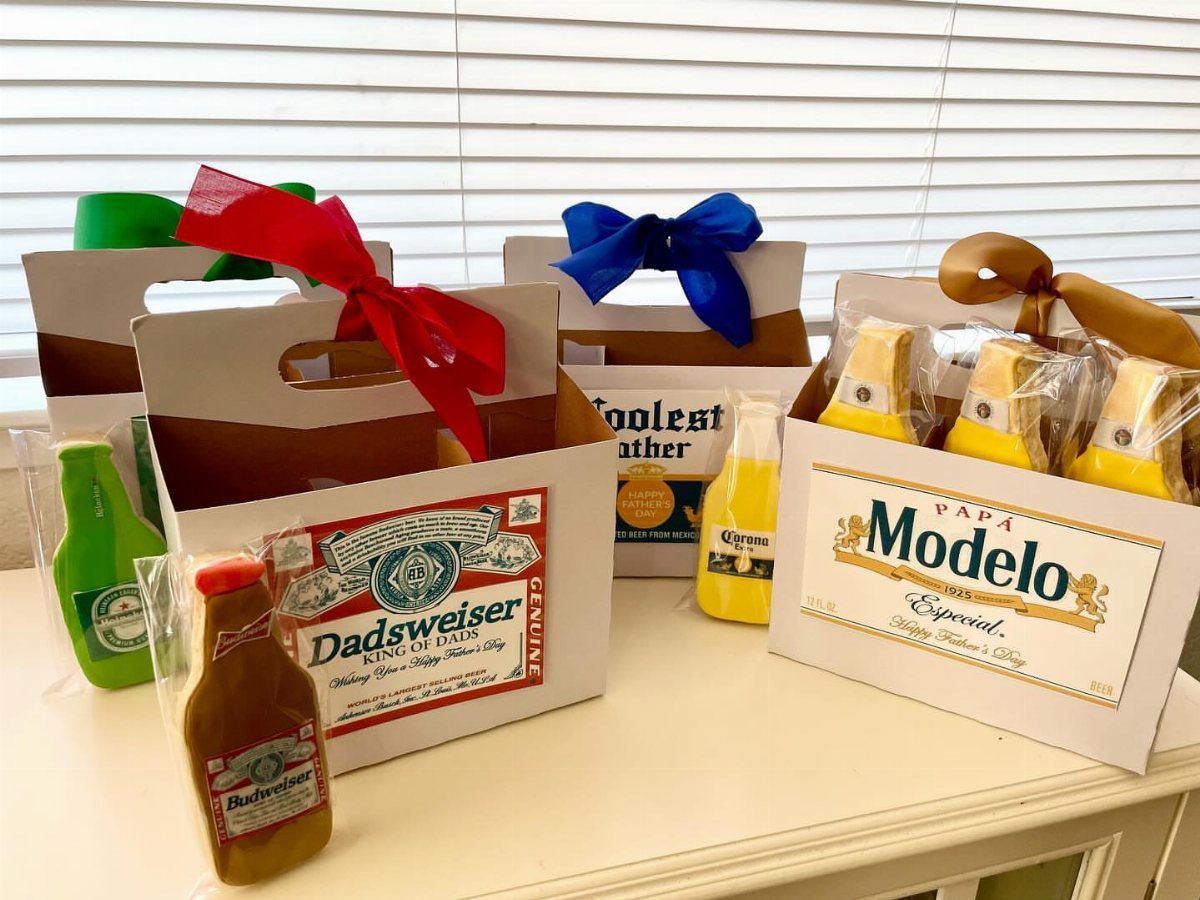 Custom beer-themed gift bags with Dadsweiser and Modelo labels and colorful ribbons.