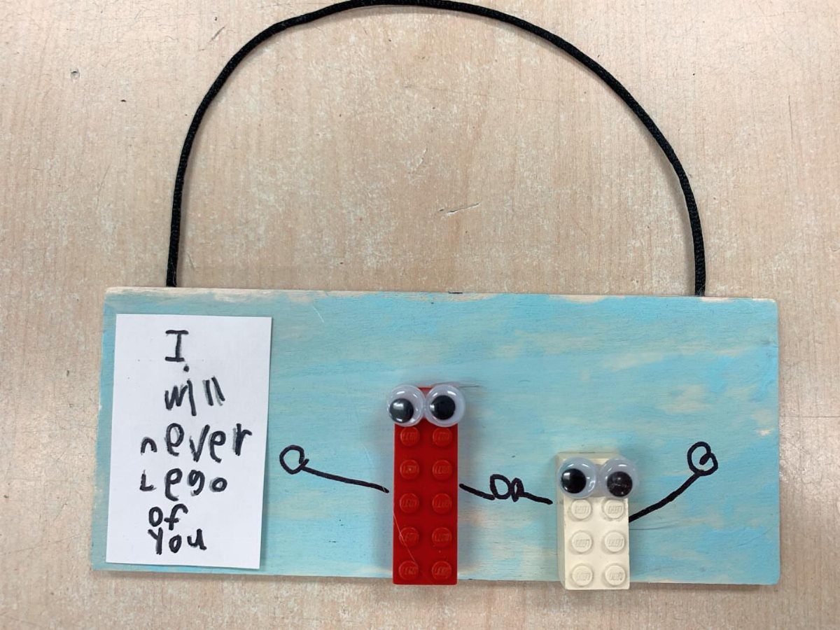 Blue wooden plaque with LEGO brick characters and a punny Father's Day note.