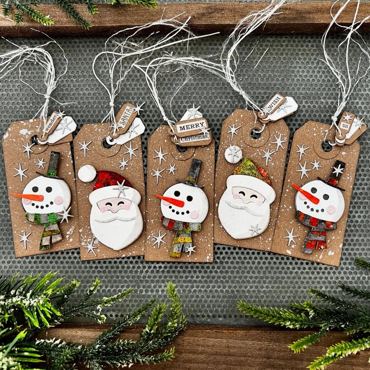 Brown kraft paper gift tags decorated with 3D clay snowmen and Santa figures.