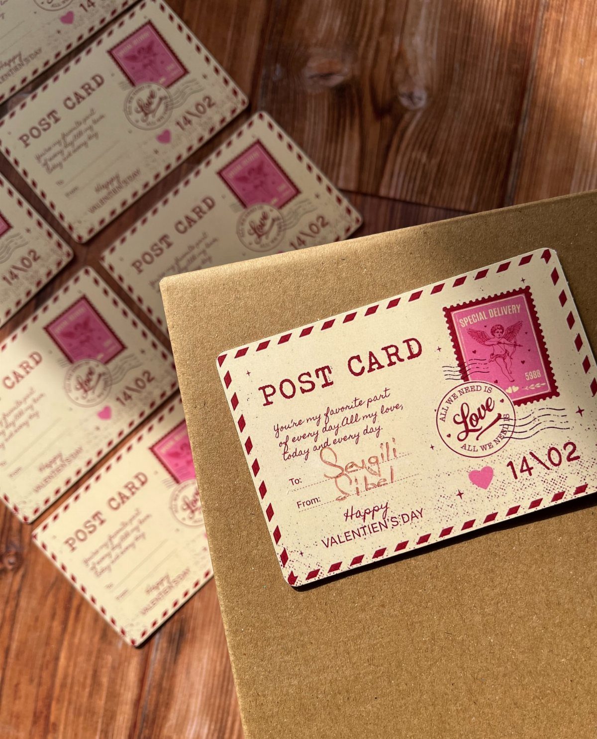 Vintage postcard style gift tags attached to a brown cardboard gift box.
