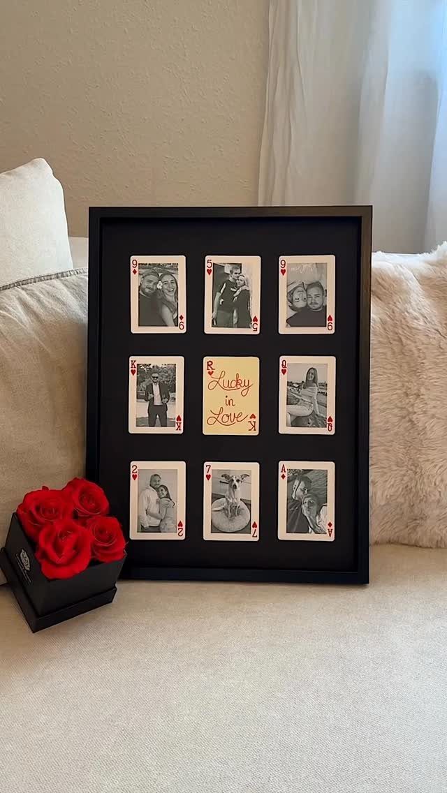 Framed playing cards with couple photos and red roses on a white surface