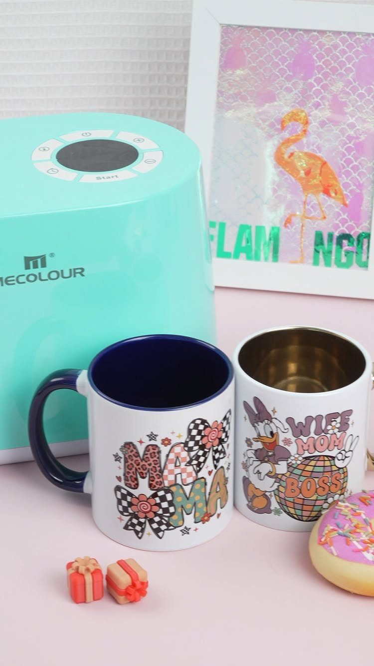 Two custom printed white mugs with colorful text and graphics on a pink surface.