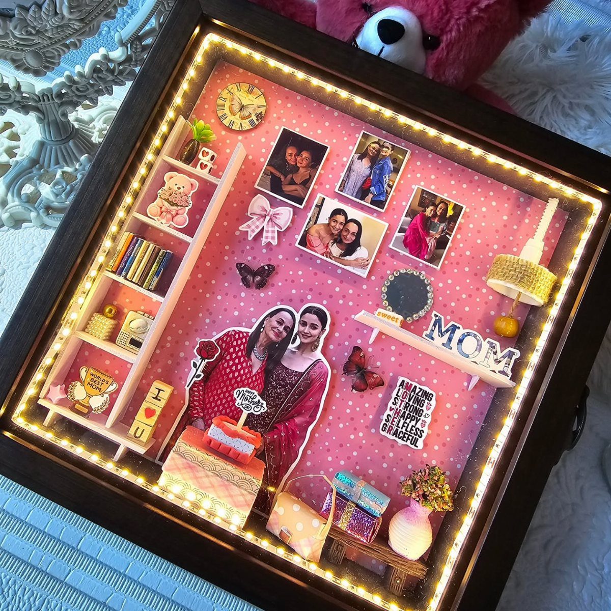 Shadow box with pink polka-dot background, family photos, and a MOM sign.