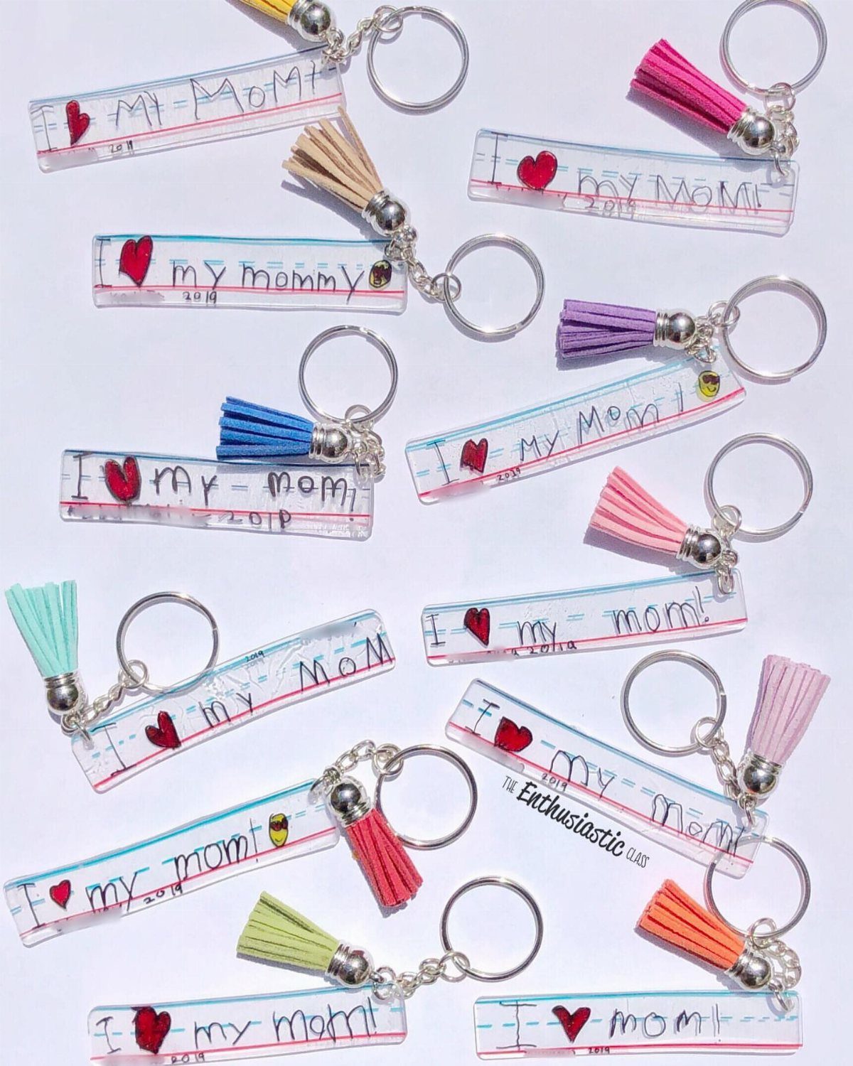 Handmade acrylic keychains with I love my mom text and colorful tassels.