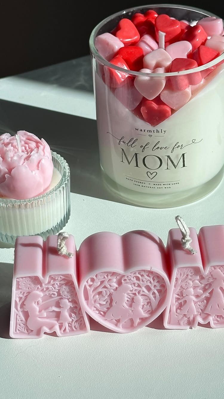 Heart-shaped and molded pink candles with a jar candle for Mom.