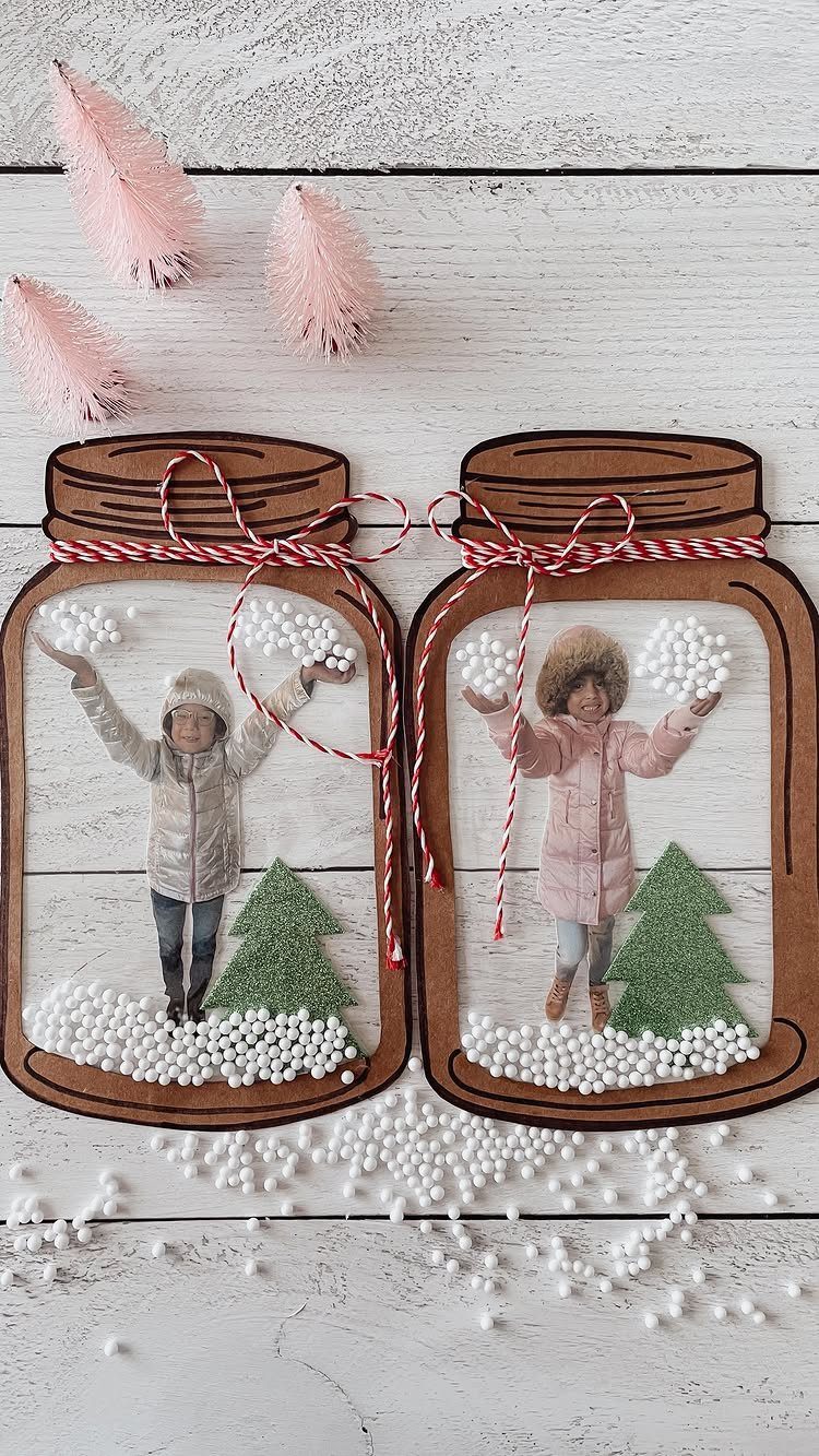 Two cardboard mason jar crafts containing photos of children in snowy winter scenes.
