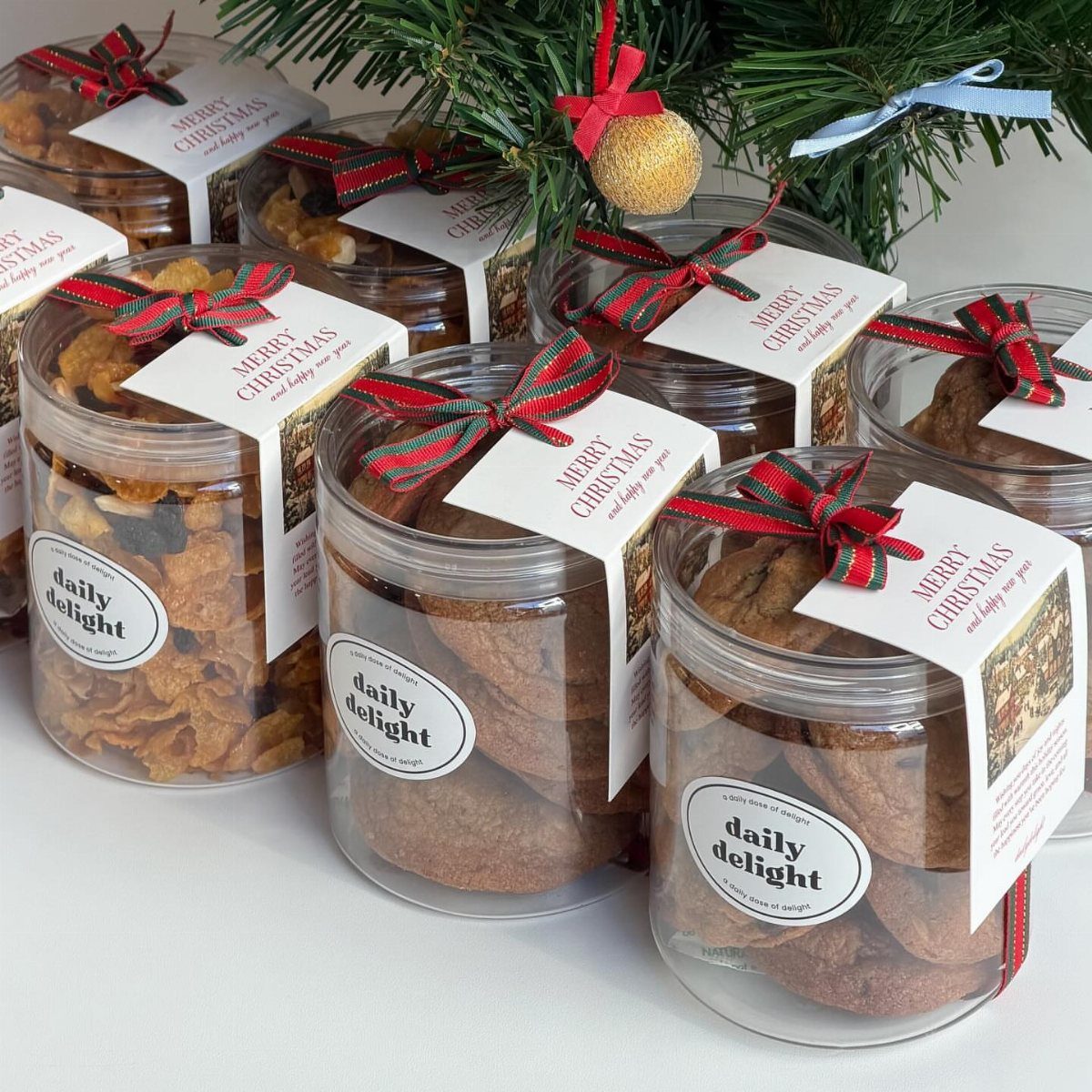Clear plastic jars filled with cookies and snacks tied with festive Christmas ribbons.