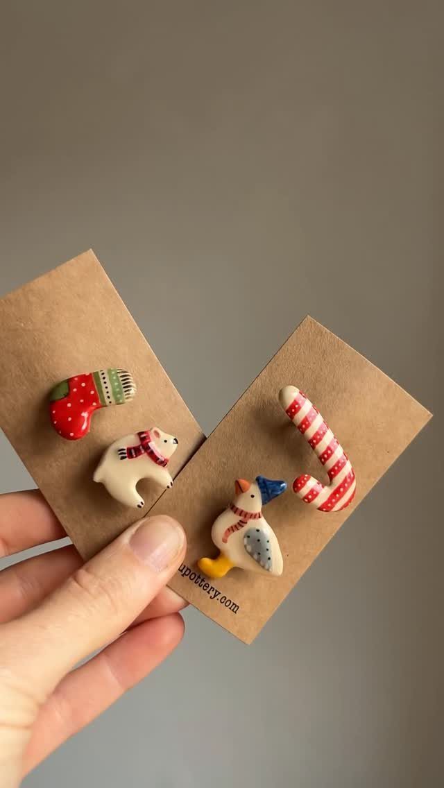 Ceramic winter-themed pins including a polar bear, penguin, stocking, and candy cane.